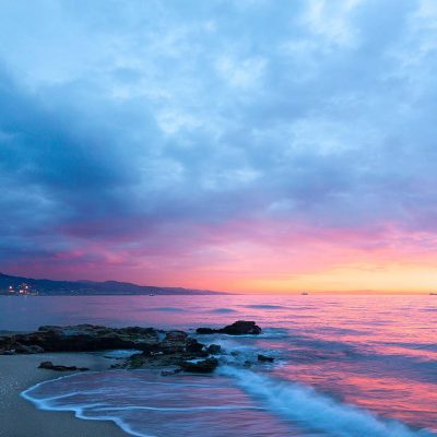 View of sunset and mountains from a beach